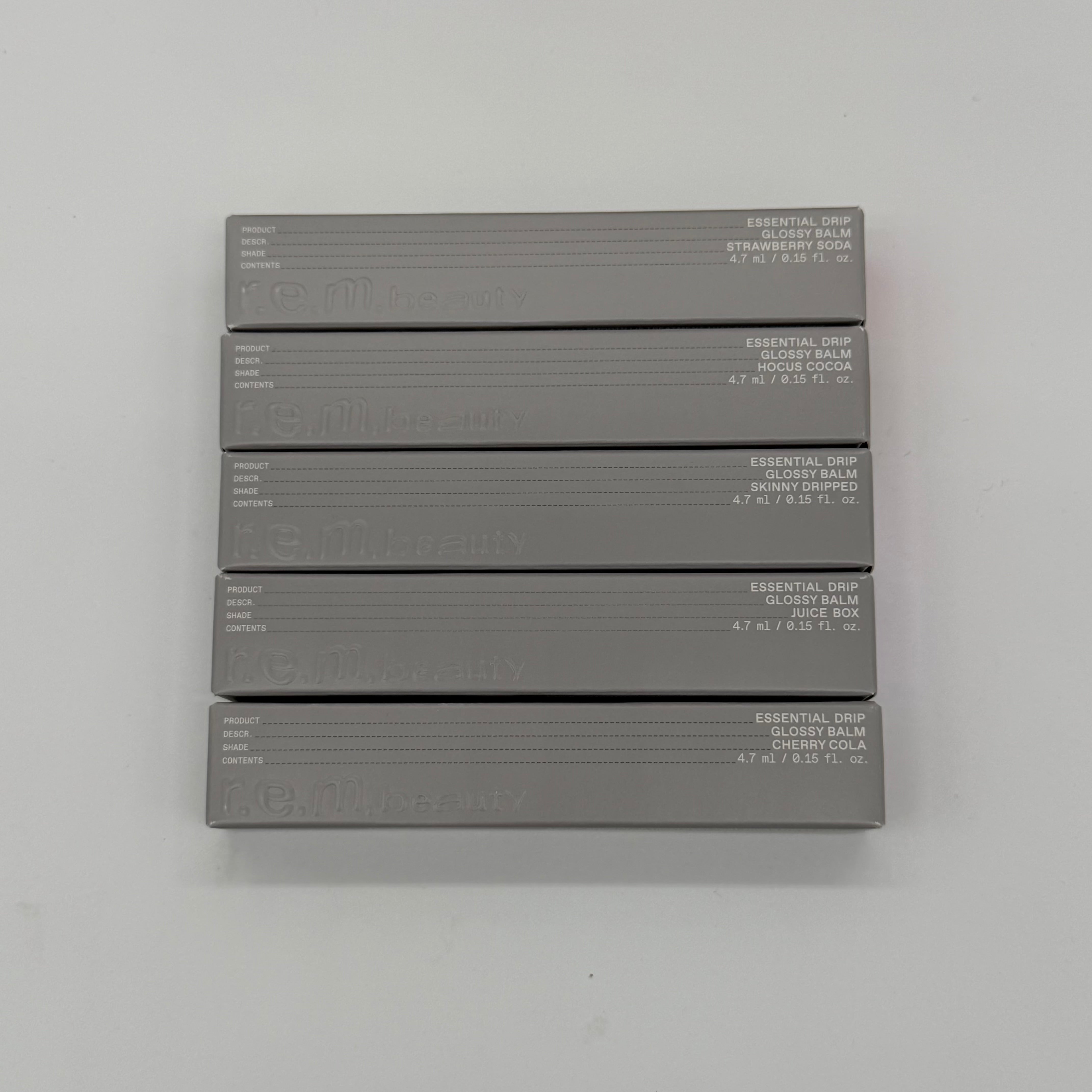 WHOLESALE R.E.M. BEAUTY ESSENTIAL DRIP GLOSSY BALM PACKAGE #2 - ASSORTED COLORS - 48 PIECE LOT